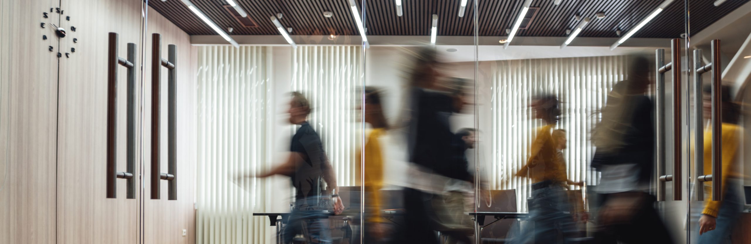 people walking in an office to represent company culture