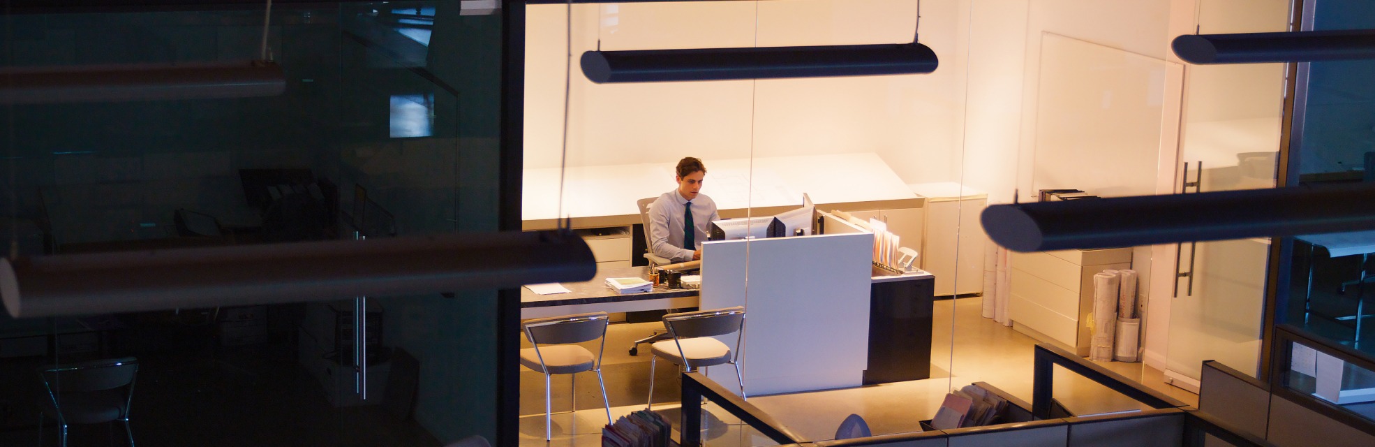 man sitting at a desk in an office to represent working on pricing strategies